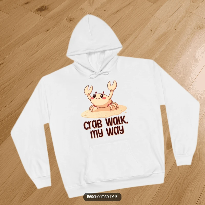 Funny crab hoodie featuring a happy crab scuttling sideways across sparkling sand, offering warmth and humorous beach vibes.
