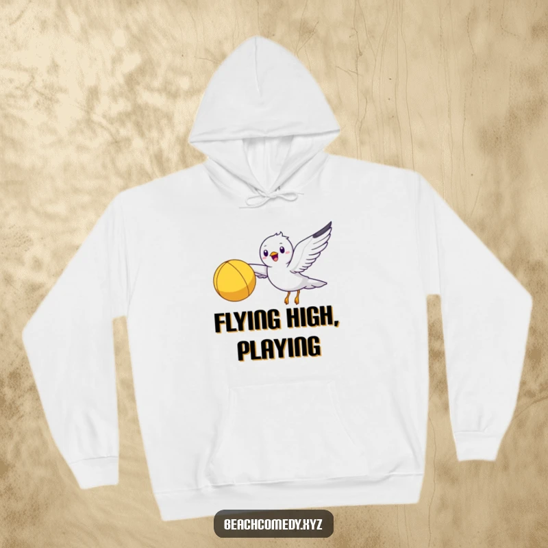 Funny seagull character flying with a beach ball, depicted on a comfortable hoodie for warm, humorous wear.